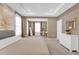 Spacious main bedroom with sitting area, large windows, and neutral color palette at 30684 Penny Surf Loop, Wesley Chapel, FL 33545