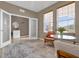 Bright sitting room with French doors and a neutral color scheme at 30684 Penny Surf Loop, Wesley Chapel, FL 33545