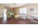Bright living room with hardwood floors, comfy seating, and access to a balcony at 315 30Th W Ave # B201, Bradenton, FL 34205
