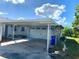 Attached carport with a single garage door at 808 White Heron Blvd, Ruskin, FL 33570