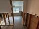 The hallway is unfinished with exposed studs and a view into the unfinished bedroom at 9018 1St N St, St Petersburg, FL 33702