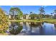 Apartment building reflected in a tranquil pond at 1450 Heather Ridge Blvd # 306, Dunedin, FL 34698