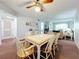 Charming dining area with a white table and six chairs at 1450 Heather Ridge Blvd # 306, Dunedin, FL 34698