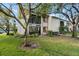 Exterior view of condo building with landscaping and lake view at 165 Lakeview Way # 165, Oldsmar, FL 34677