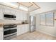 Kitchen with white cabinets, granite counters, and stainless steel appliances at 165 Lakeview Way # 165, Oldsmar, FL 34677