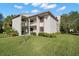Two-story condo building with balcony and landscaping at 165 Lakeview Way # 165, Oldsmar, FL 34677