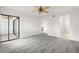 Spacious bedroom with grey carpet, sliding door to balcony, and ceiling fan at 165 Lakeview Way # 165, Oldsmar, FL 34677