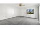 Bright bedroom with grey carpet, window with garden view, and ceiling fan at 165 Lakeview Way # 165, Oldsmar, FL 34677