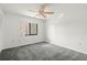 Bedroom with grey carpet, window, and ceiling fan at 165 Lakeview Way # 165, Oldsmar, FL 34677