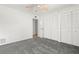 Bedroom with grey carpet, double door closet, and ceiling fan at 165 Lakeview Way # 165, Oldsmar, FL 34677