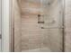 Shower stall with beige tile, glass door, and built-in shelf at 165 Lakeview Way # 165, Oldsmar, FL 34677