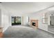 Living room with fireplace, sliding glass doors, and grey carpet at 165 Lakeview Way # 165, Oldsmar, FL 34677