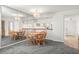 Bright dining room with wood table and chairs, mirror, and access to kitchen at 165 Lakeview Way # 165, Oldsmar, FL 34677
