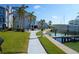 Community waterfront access featuring grassy area, a walkway, boat docks, and nearby condos at 179 Medallion Blvd # C, Madeira Beach, FL 33708