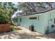 Charming light teal home with a walkway and wooden fence at 1820 1/2 N Washington Ave, Clearwater, FL 33755