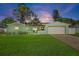 Charming light green house with a two-car garage and landscaped yard at 3887 50Th S Ave, St Petersburg, FL 33711