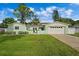 Light green house with a two-car garage and a large front yard at 3887 50Th S Ave, St Petersburg, FL 33711