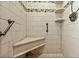 Large shower with tiled walls, seat, and grab bars at 3887 50Th S Ave, St Petersburg, FL 33711