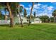 Light green house with palm trees and a two-car garage at 3887 50Th S Ave, St Petersburg, FL 33711