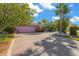 Pink house with a large brick driveway and attached garage at 6331 Cocoa Ln, Apollo Beach, FL 33572