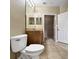 Bathroom featuring a vanity, toilet, tile floor, and doorway to walk-in closet at 10108 Courtney Oaks Cir # 203, Tampa, FL 33619