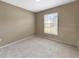 Carpeted bedroom featuring a window, neutral walls, and electrical outlets at 10108 Courtney Oaks Cir # 203, Tampa, FL 33619