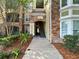 Exterior view of the condo complex showing stairs leading to units with stone facade and building number at 10108 Courtney Oaks Cir # 203, Tampa, FL 33619