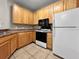 Kitchen with wooden cabinets, granite counters, and stainless steel appliances at 10108 Courtney Oaks Cir # 203, Tampa, FL 33619