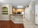 Open concept kitchen featuring wood floors flowing to kitchen, white appliances, and neutral color palette at 10108 Courtney Oaks Cir # 203, Tampa, FL 33619