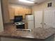 Bright kitchen features wood cabinets, laminate counter tops, and white appliances at 10108 Courtney Oaks Cir # 203, Tampa, FL 33619