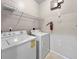 Laundry room features a washer, a dryer, and wire shelving at 10108 Courtney Oaks Cir # 203, Tampa, FL 33619
