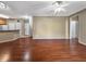 Bright and airy living room showcasing hardwood floors, open layout, and access to kitchen area at 10108 Courtney Oaks Cir # 203, Tampa, FL 33619
