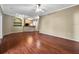 Spacious living room with hardwood floors, neutral walls, and open layout to the kitchen at 10108 Courtney Oaks Cir # 203, Tampa, FL 33619