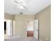 Bedroom with a ceiling fan, neutral walls, and multiple doorways at 10108 Courtney Oaks Cir # 203, Tampa, FL 33619