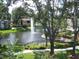 View of the community pond with fountain, lush landscaping, and walkways at 10108 Courtney Oaks Cir # 203, Tampa, FL 33619