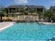 Community pool with a water feature cascading into the pool at 10108 Courtney Oaks Cir # 203, Tampa, FL 33619