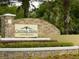 Community entrance sign displaying 'Courtney Palms Condominium' with decorative stone and landscaping at 10108 Courtney Oaks Cir # 203, Tampa, FL 33619