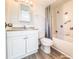 Modern bathroom with a shower/tub combo, white vanity, and gray curtain at 220 N Bayshore Blvd # 108, Clearwater, FL 33759