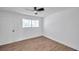 Bright bedroom with ceiling fan and wood-look tile flooring at 2353 Shelley St # 16, Clearwater, FL 33765