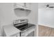 Modern kitchen features a stainless steel range and white shaker cabinets at 2353 Shelley St # 16, Clearwater, FL 33765