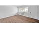 Living room with large window, wood-look floors, and AC unit at 2353 Shelley St # 16, Clearwater, FL 33765