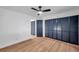 Spacious bedroom with wood floors, ceiling fan, and multiple closets at 2353 Shelley St # 4, Clearwater, FL 33765