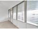 Enclosed patio with window louvers and exterior door at 2353 Shelley St # 4, Clearwater, FL 33765