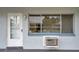White door and window, brick building exterior, ac unit at 2353 Shelley St # 4, Clearwater, FL 33765