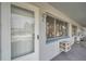 White door with window and ac unit on brick wall at 2353 Shelley St # 4, Clearwater, FL 33765