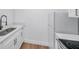 Modern kitchen with white cabinets, quartz countertops and black faucet at 2353 Shelley St # 4, Clearwater, FL 33765