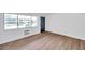 Living room with hardwood floors, large window, and dark door at 2353 Shelley St # 4, Clearwater, FL 33765