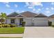 One-story home with two-car garage and well-manicured landscaping at 5085 Ivory Stone Dr, Wimauma, FL 33598