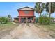 Two-story red house with attached garage at 5092 Cedarbrook Ln, Hernando Beach, FL 34607