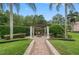 Landscaped patio with fire pit and pergola at 531 Isleworth Close, Tarpon Springs, FL 34688